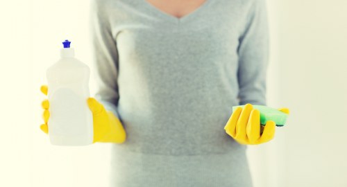 Technician handling carpet cleaning chemicals carefully